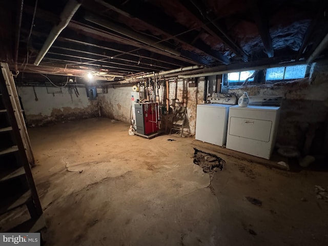 basement with washing machine and clothes dryer and electric panel