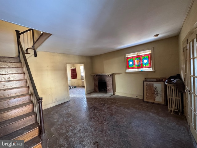 unfurnished living room with a brick fireplace