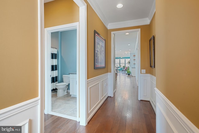 hall with crown molding and hardwood / wood-style floors