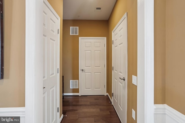 hallway with dark wood-type flooring