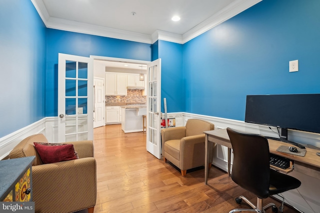 office area featuring crown molding, light hardwood / wood-style flooring, and french doors