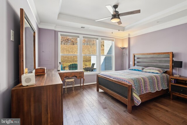 bedroom featuring crown molding, ceiling fan, dark hardwood / wood-style floors, and a raised ceiling