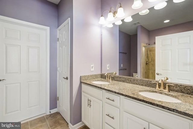 bathroom featuring walk in shower, vanity, toilet, and tile patterned flooring