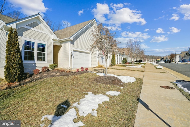 view of property exterior featuring a garage and a yard