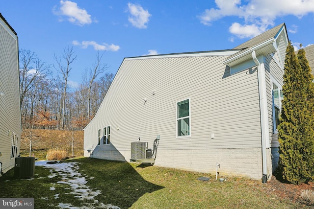 view of home's exterior with a yard and central air condition unit