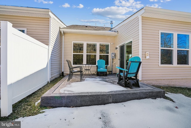 snow covered property featuring a patio