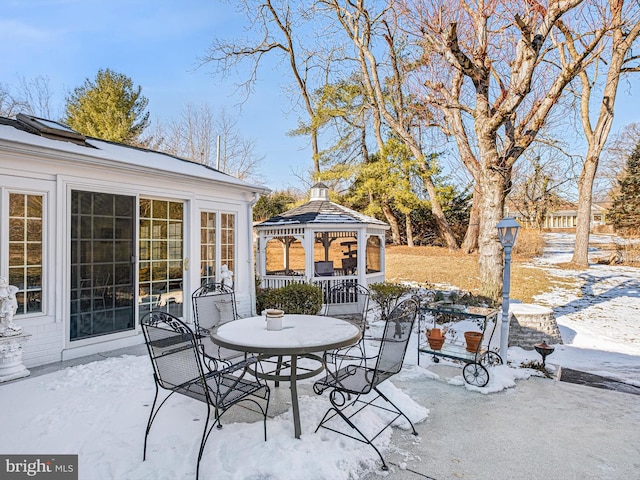 snow covered patio with a gazebo