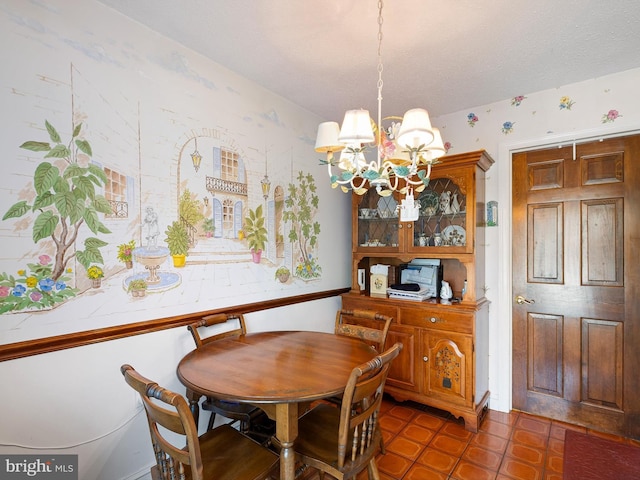 dining room with a notable chandelier and a textured ceiling