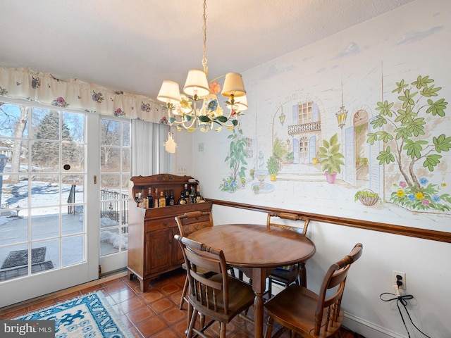 tiled dining area featuring an inviting chandelier and a textured ceiling