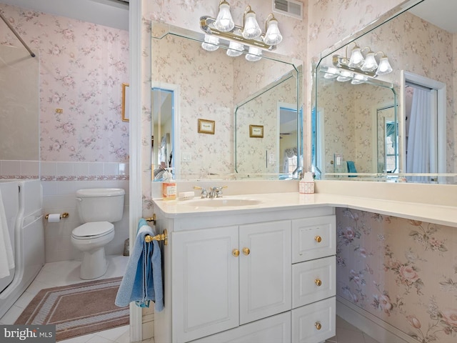 bathroom featuring vanity, tile patterned floors, tile walls, and toilet