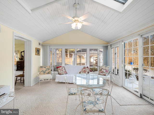 sunroom / solarium with ceiling fan and lofted ceiling with skylight