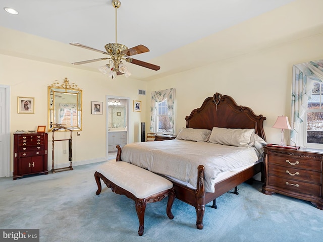 carpeted bedroom with ceiling fan and ensuite bathroom