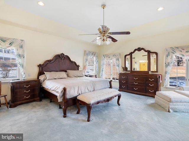 bedroom featuring ceiling fan and light carpet