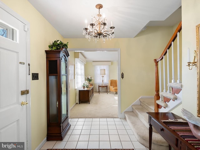 foyer featuring light tile patterned floors and a notable chandelier