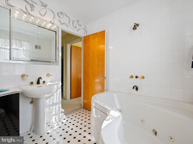 bathroom with tile walls and a bathtub