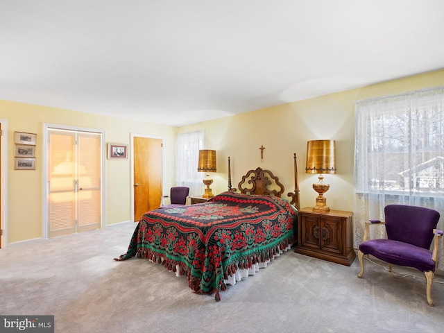 bedroom with multiple windows and light colored carpet