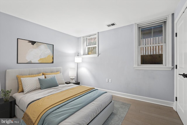 bedroom with hardwood / wood-style floors