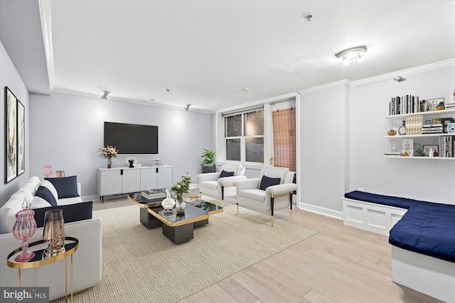 living room featuring light wood-type flooring and ornamental molding