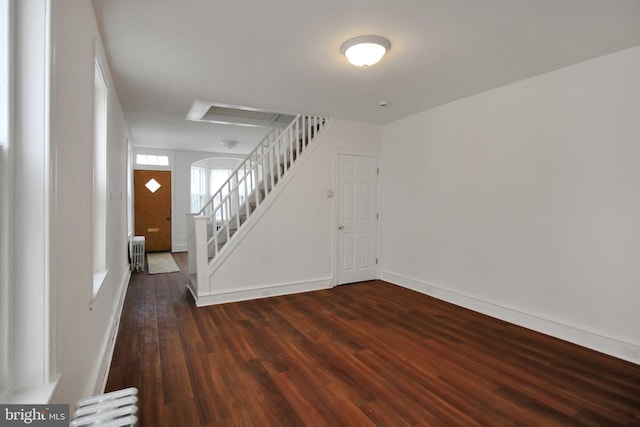 entrance foyer featuring radiator heating unit and dark hardwood / wood-style floors