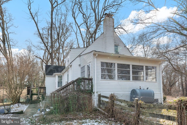 view of side of home featuring a sunroom