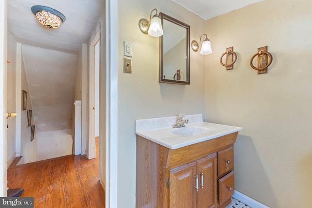 bathroom with hardwood / wood-style floors and vanity