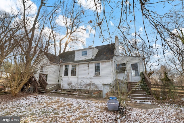 view of snow covered back of property