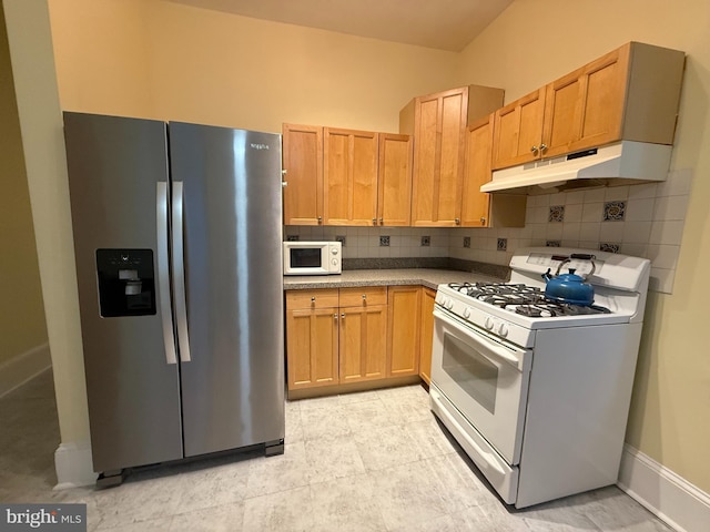 kitchen with white appliances and backsplash