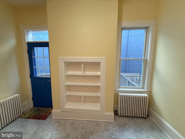 doorway featuring plenty of natural light and radiator heating unit