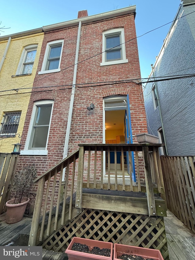 back of house with a wooden deck