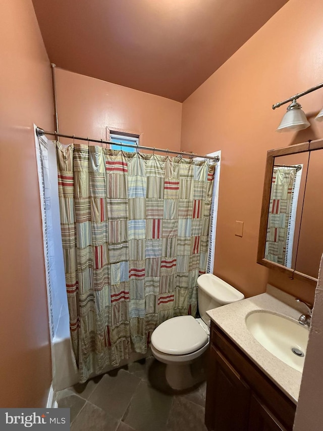 full bathroom with vanity, shower / tub combo, tile patterned floors, and toilet