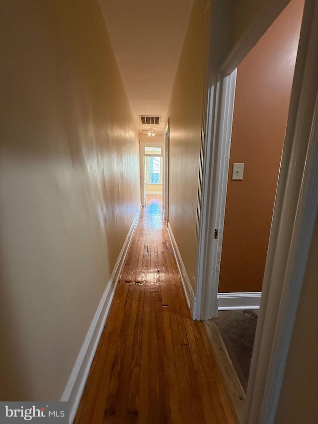 corridor with wood-type flooring