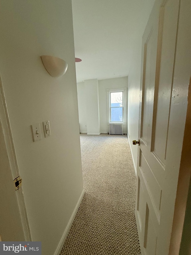 hall with radiator and light carpet