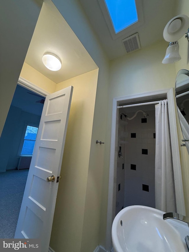 bathroom with a shower with shower curtain and sink