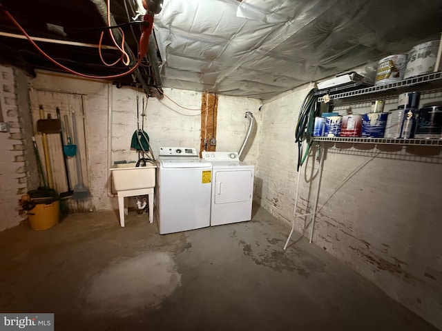 basement with separate washer and dryer and sink