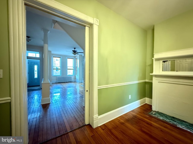 hall with dark hardwood / wood-style flooring and decorative columns