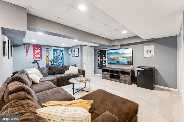 living room with light carpet and a drop ceiling