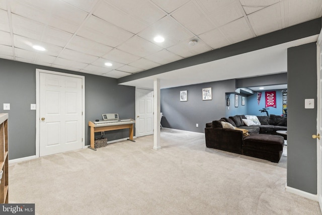 living room with light colored carpet and a drop ceiling