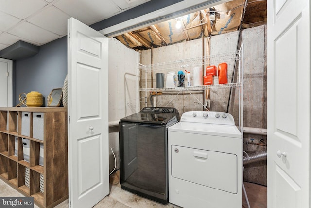 clothes washing area with washing machine and dryer