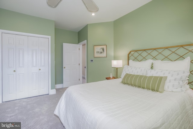 carpeted bedroom with ceiling fan and a closet