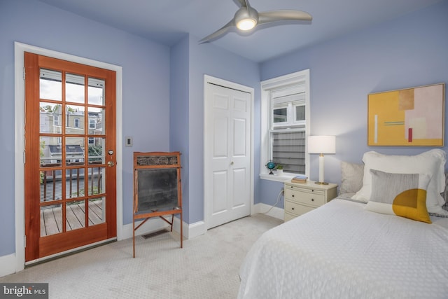 carpeted bedroom with ceiling fan and a closet