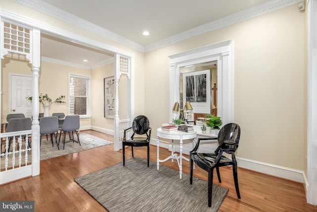 living area featuring crown molding and hardwood / wood-style floors