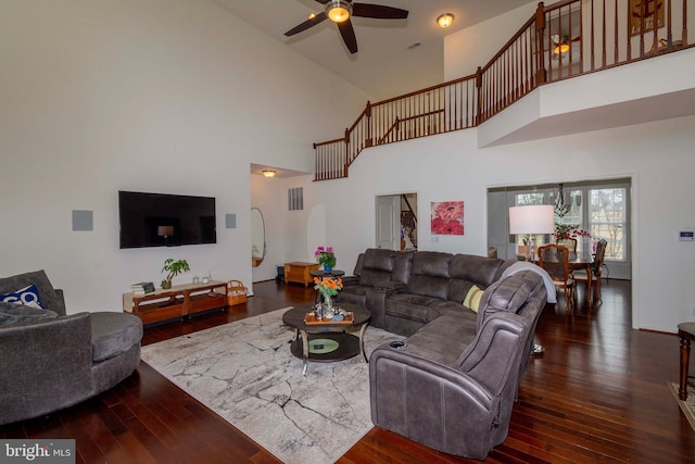 living room with ceiling fan and dark hardwood / wood-style floors