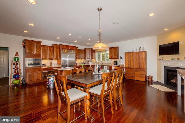 dining space featuring dark wood-type flooring