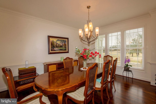 dining room featuring crown molding, dark hardwood / wood-style floors, and a chandelier