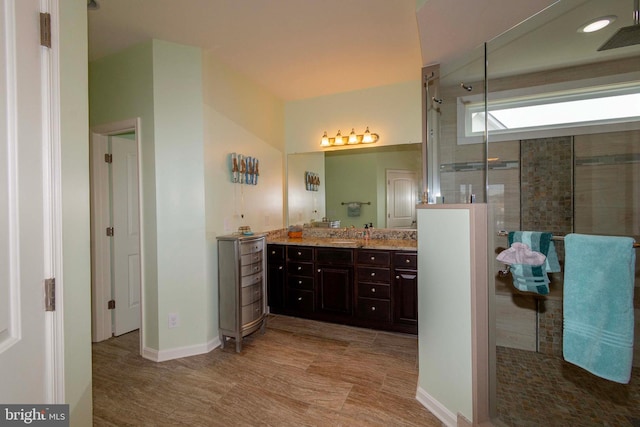 bathroom featuring vanity and an enclosed shower