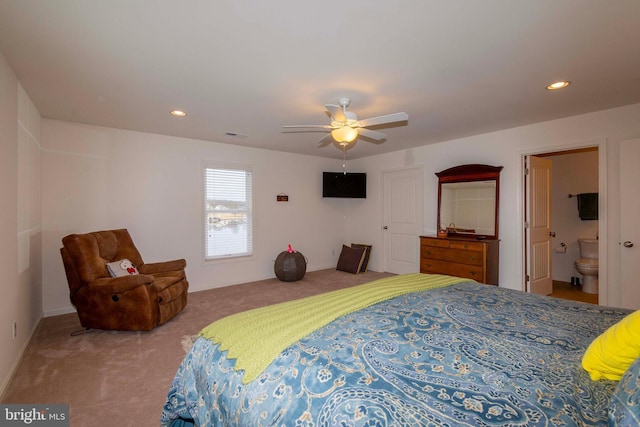 carpeted bedroom featuring ensuite bath and ceiling fan