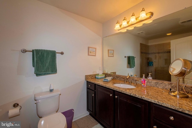 bathroom featuring vanity, toilet, and tile patterned flooring