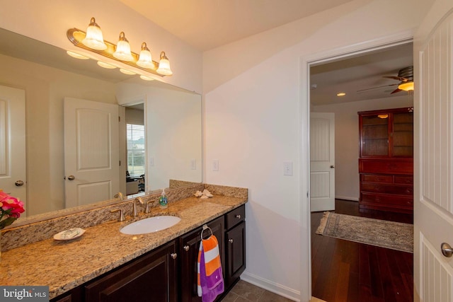 bathroom with ceiling fan, vanity, and wood-type flooring