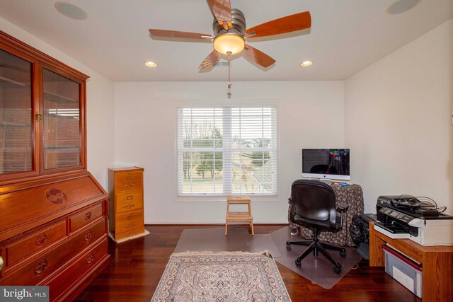 home office with dark hardwood / wood-style floors and ceiling fan