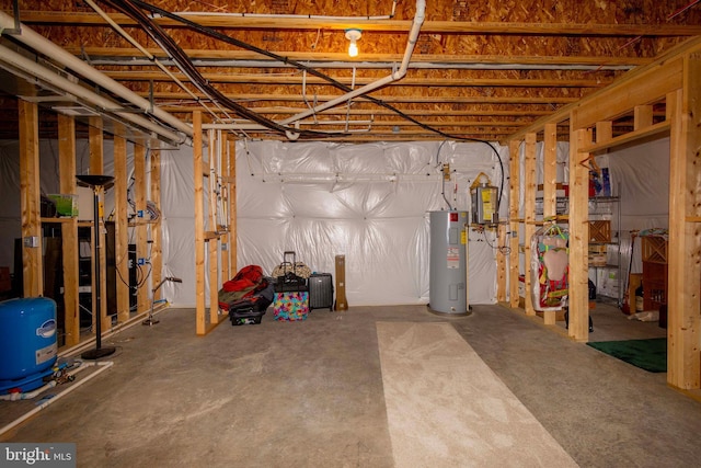 basement featuring electric panel and electric water heater